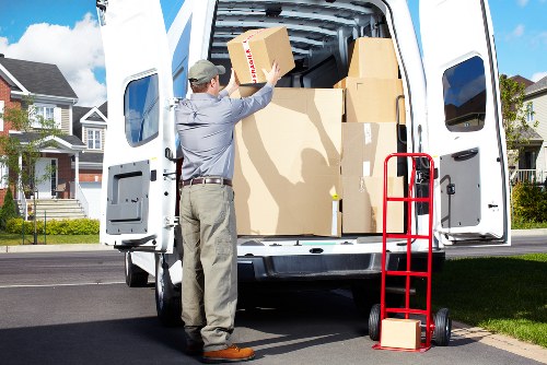 Professional movers carrying furniture through a South Lambeth flat entrance